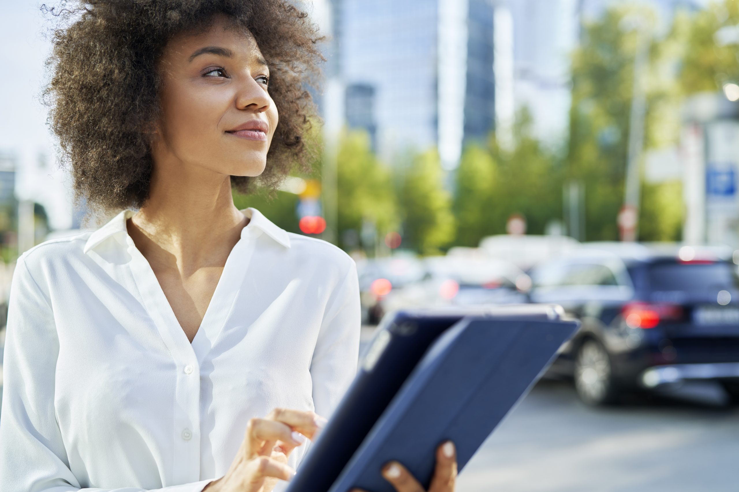 Businesswoman with digital tablet in the city