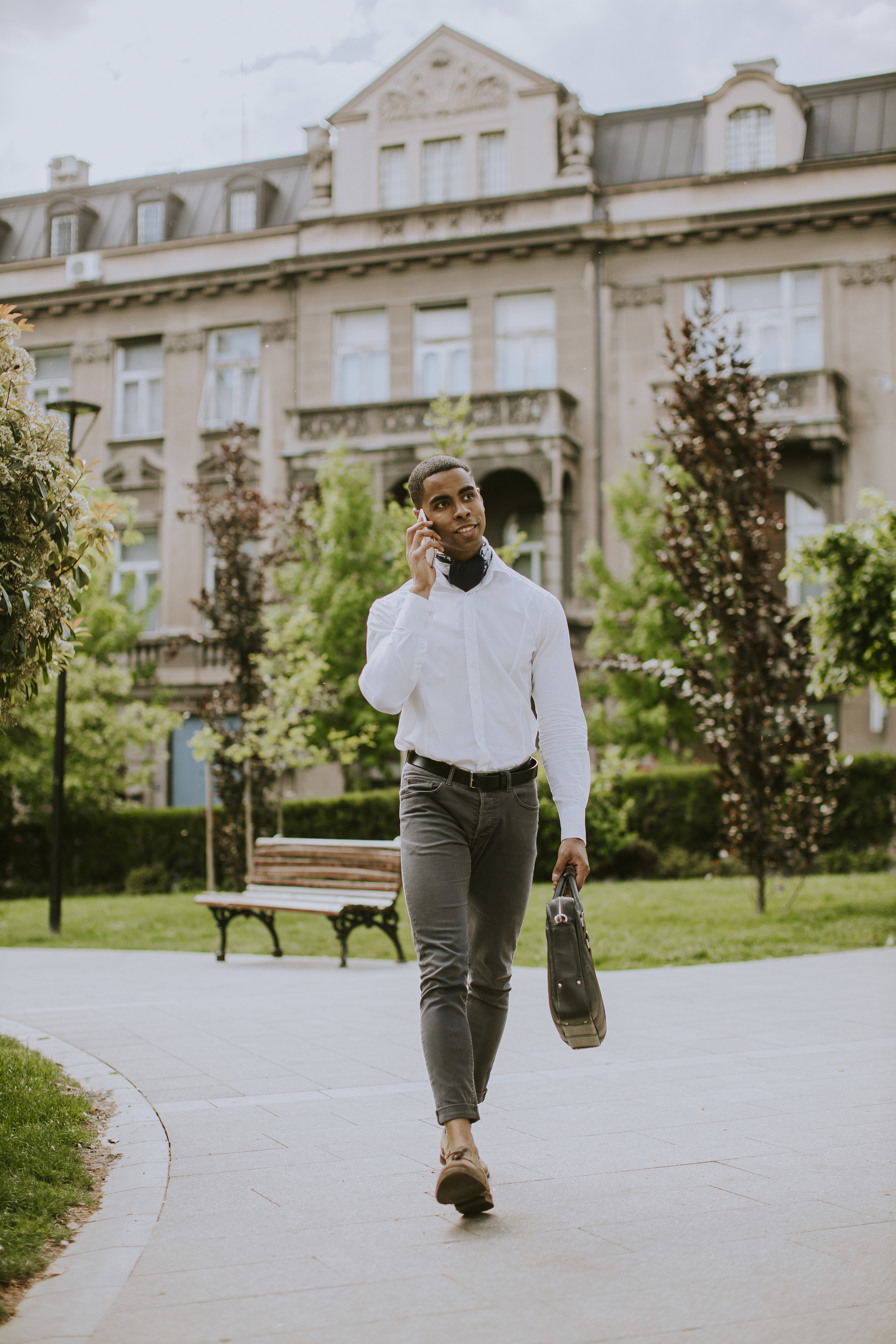 Young African American businessman using a mobile phone on a str