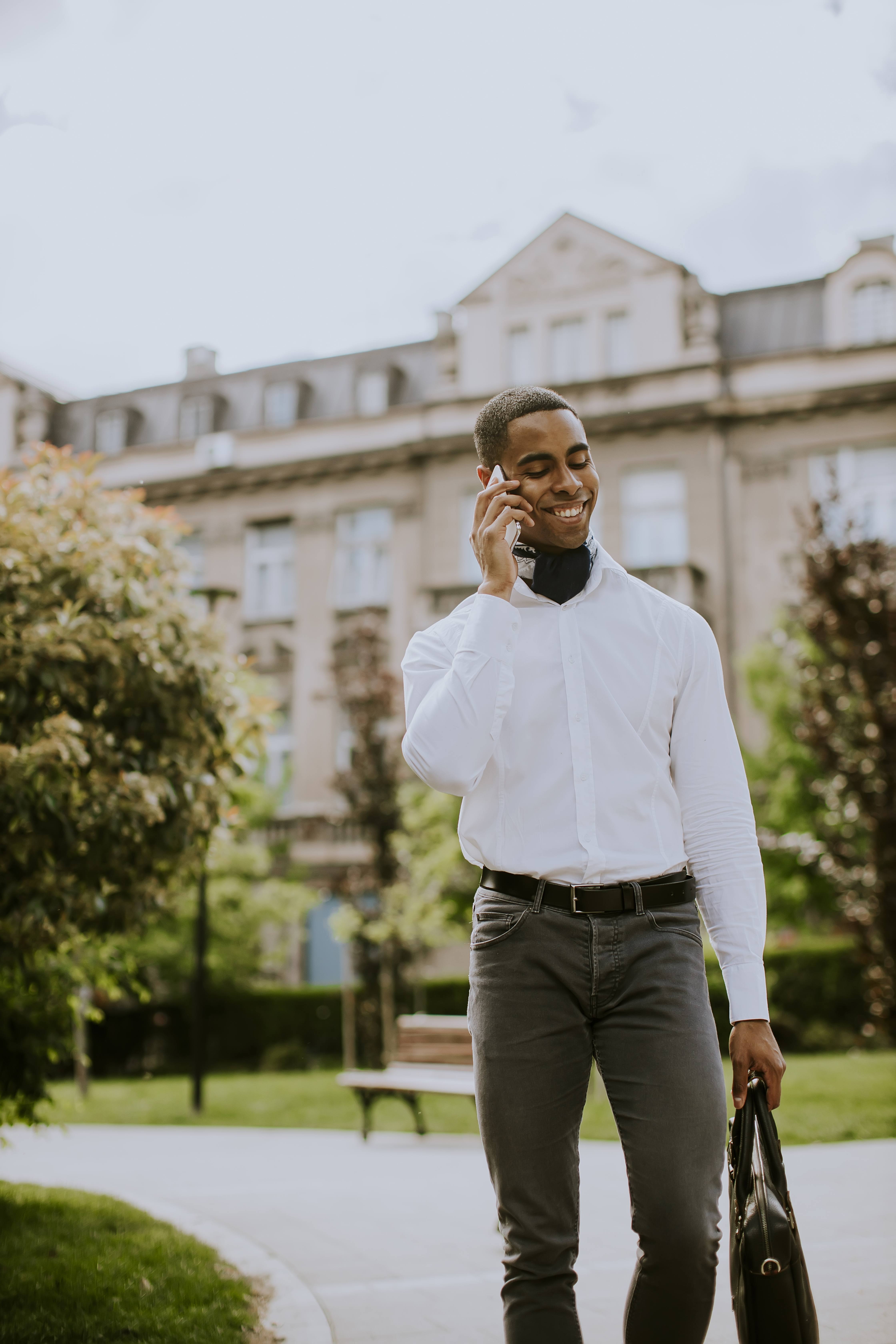 Young African American businessman using a mobile phone on a str